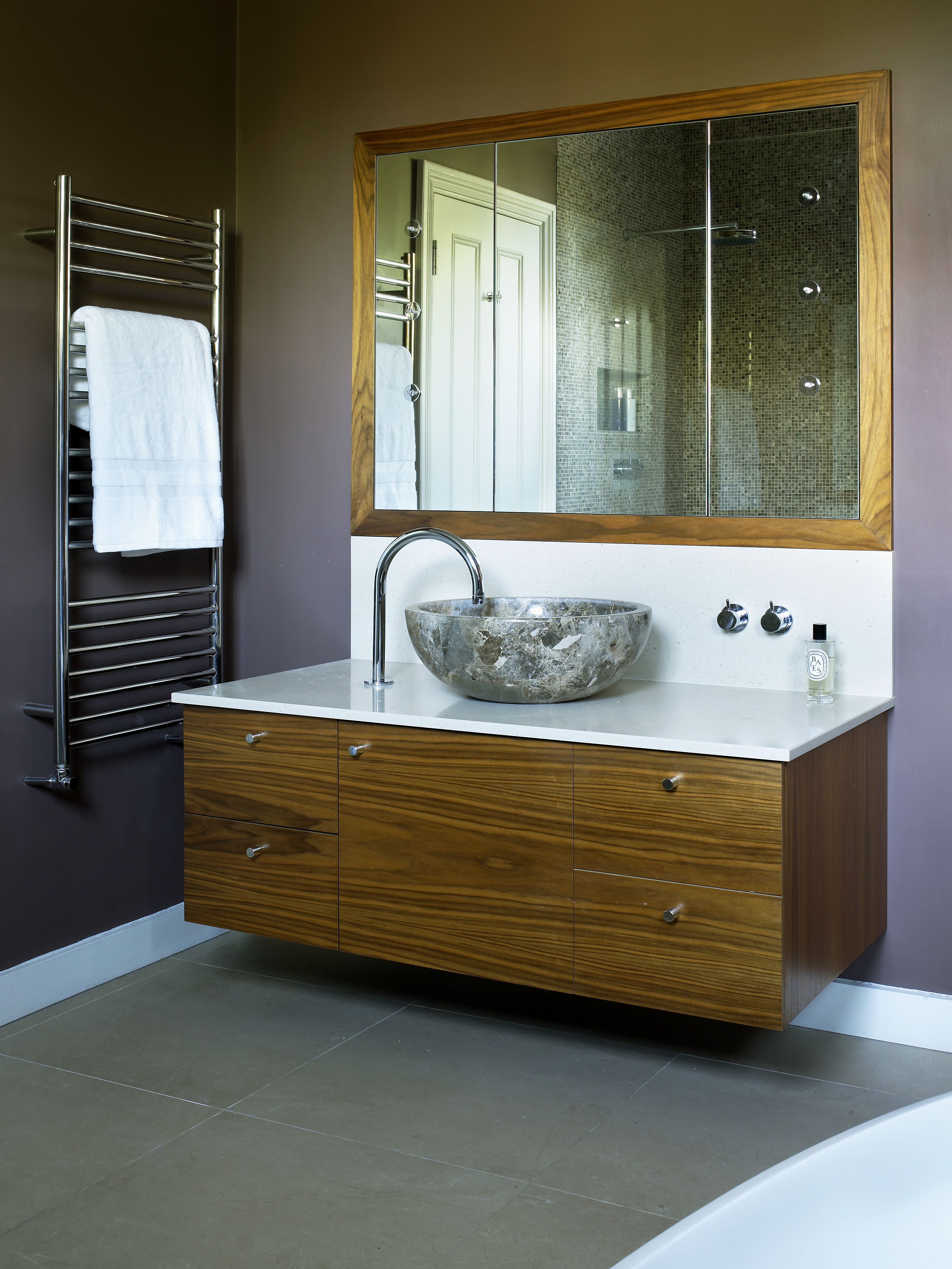 Bespoke walnut vanity unit with Marron honed marble basin.