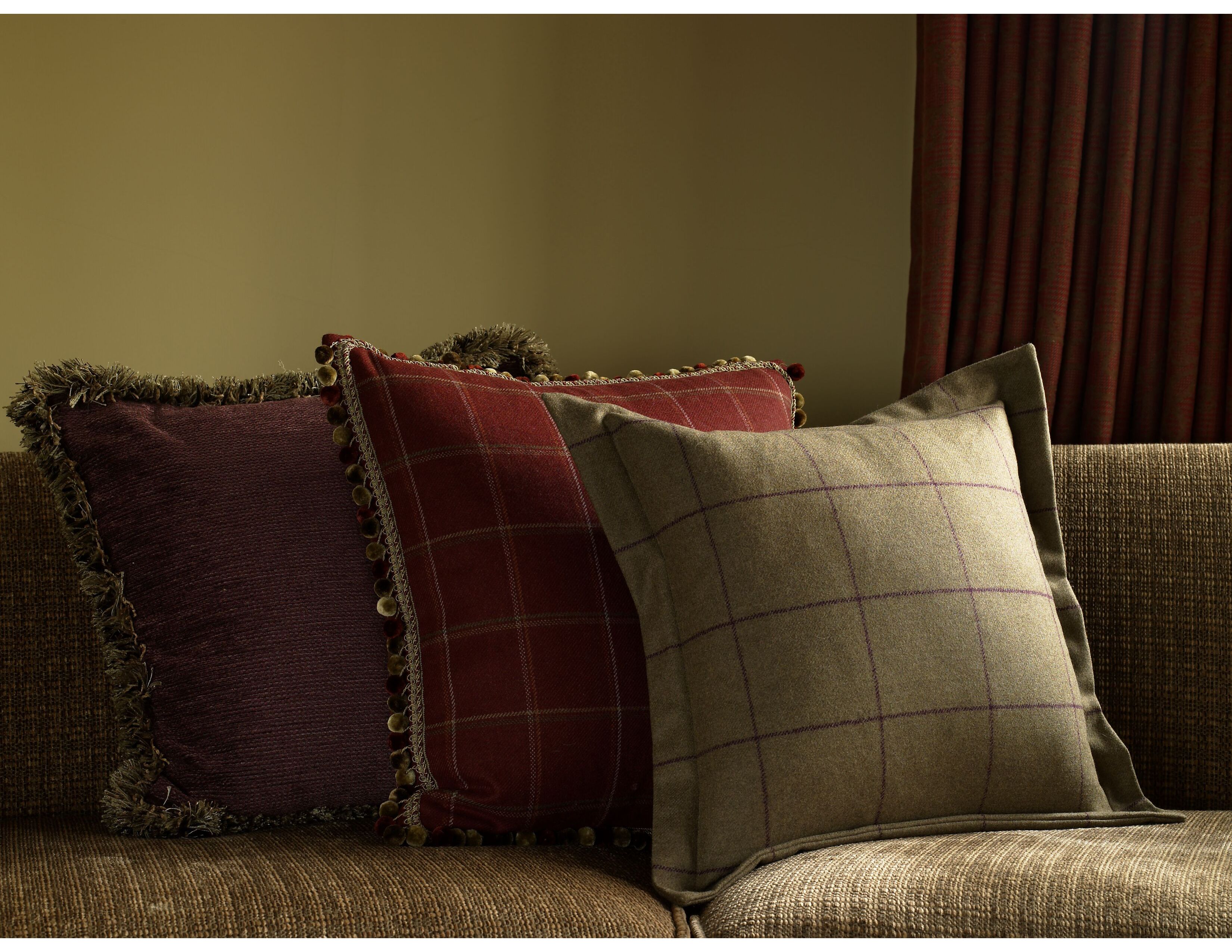 Sofa cushions in wool check and velvet fabrics.