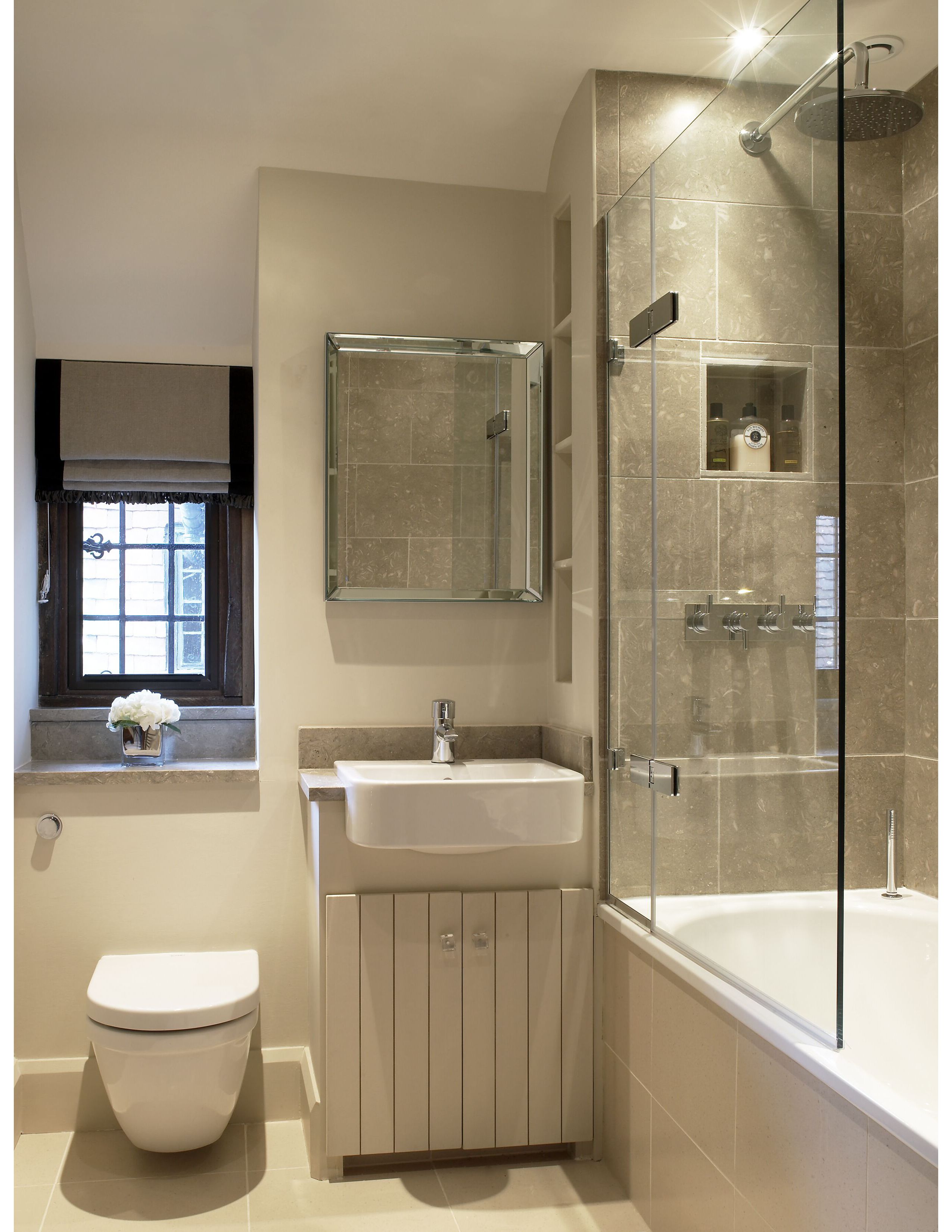 Maron honed marble used with metallic floral wallpaper in cloakroom scheme.