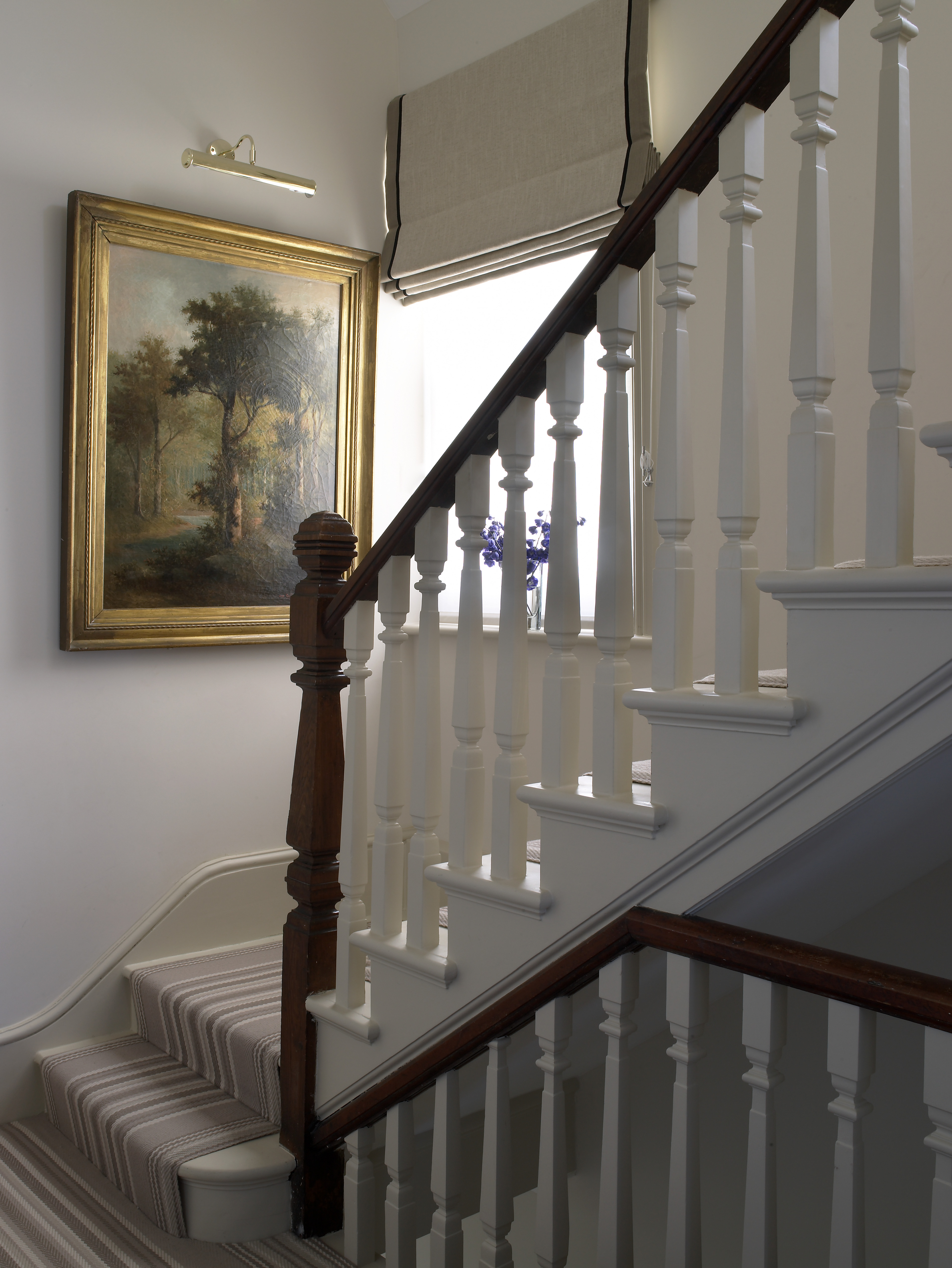 Staircase and hallway with Roger Oates striped wool runner and roman blind with contrast tape border.